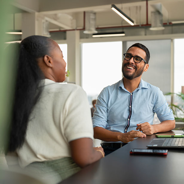 Diversebusiness people having meeting in modern office and laughing