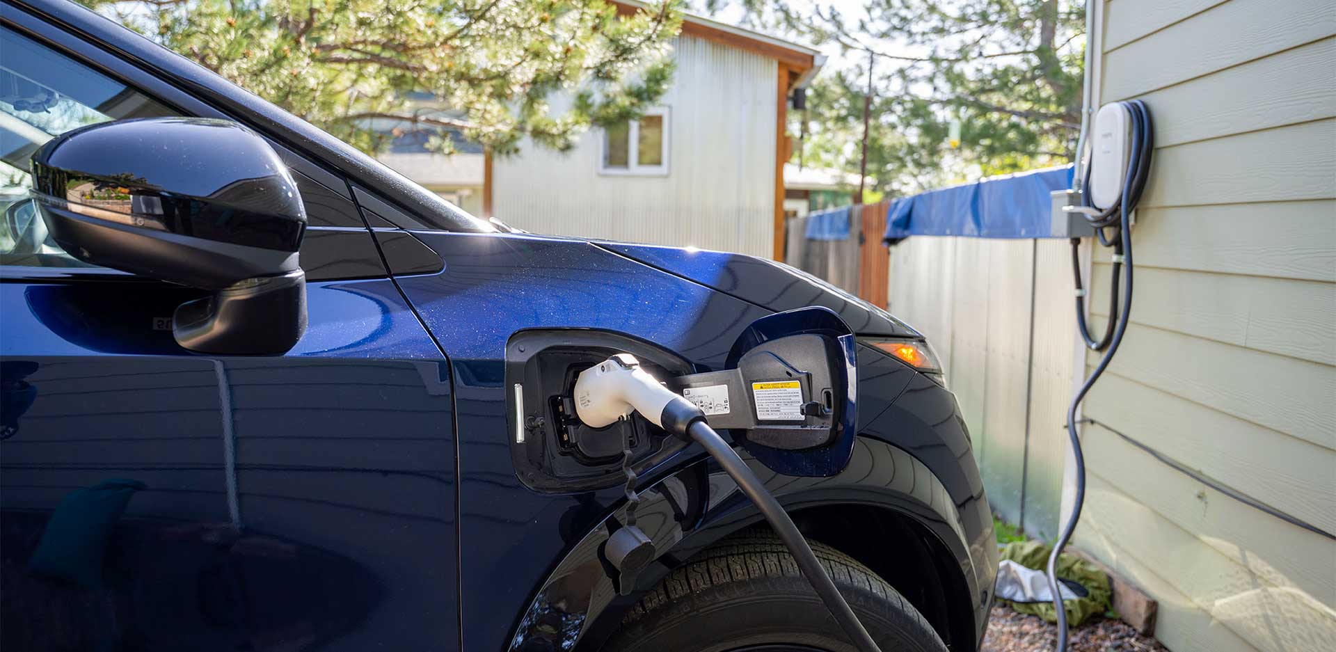 An electric vehicle being charged at a residential home.