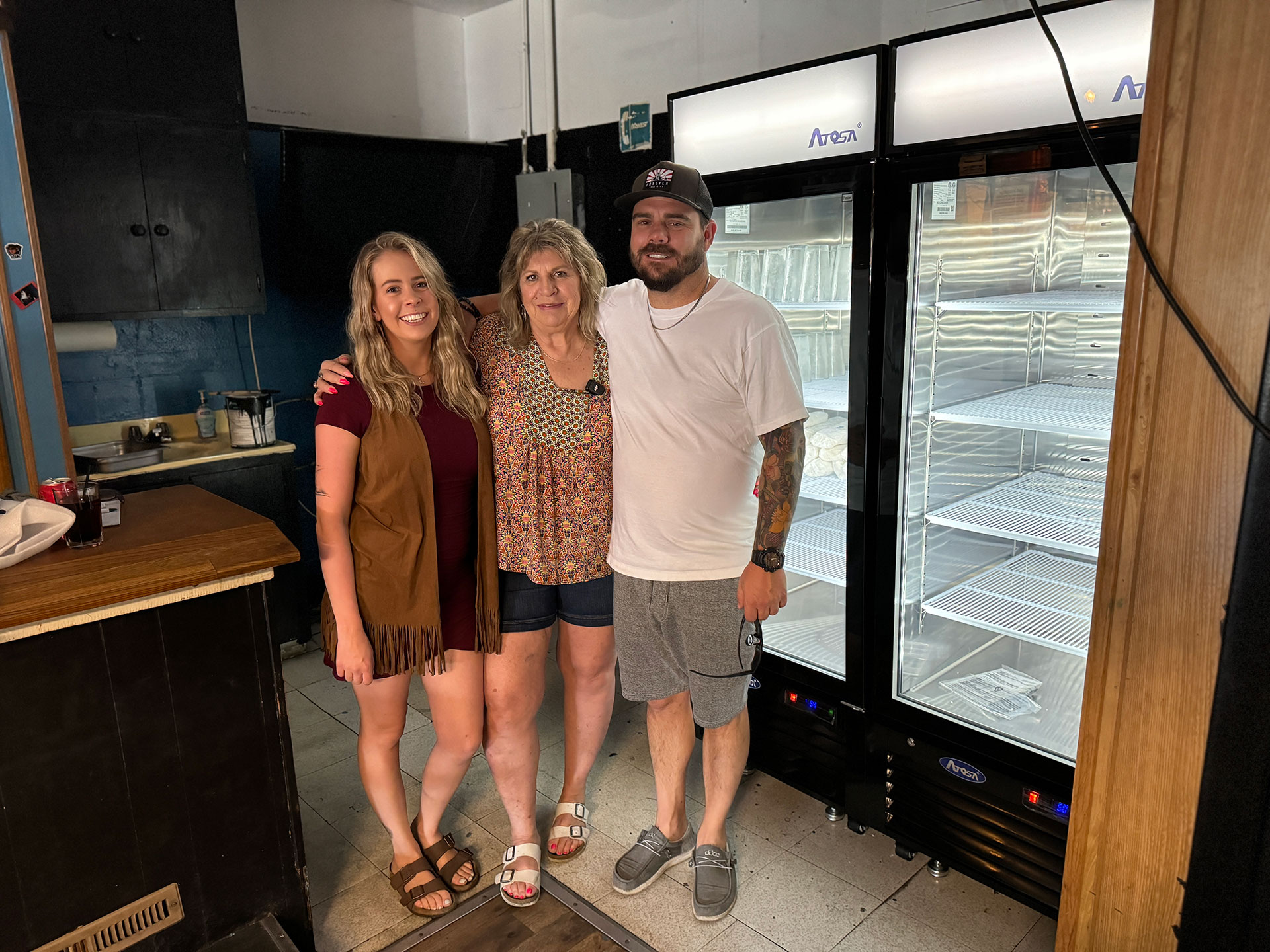 Henry's owners stand in front of a cooler that PACE grants helped fund.