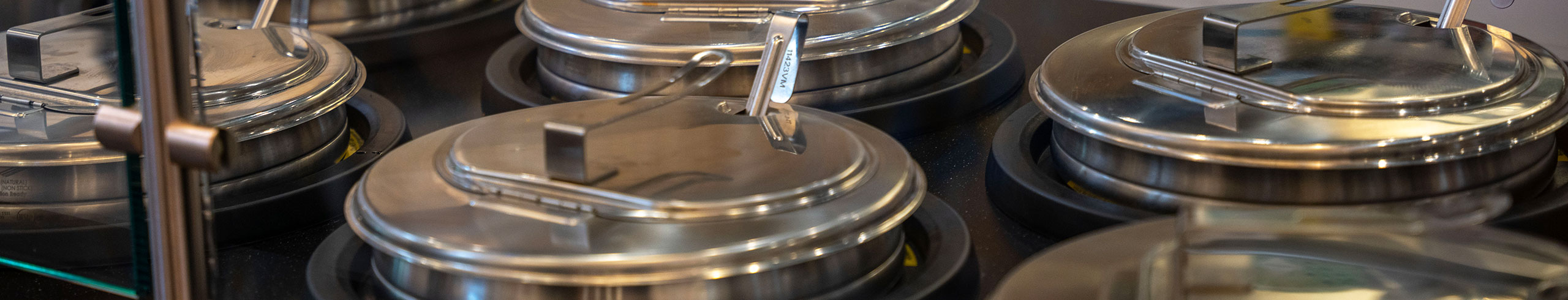 Kitchen-Equipment-Header Close up of an electric soup warming bay.