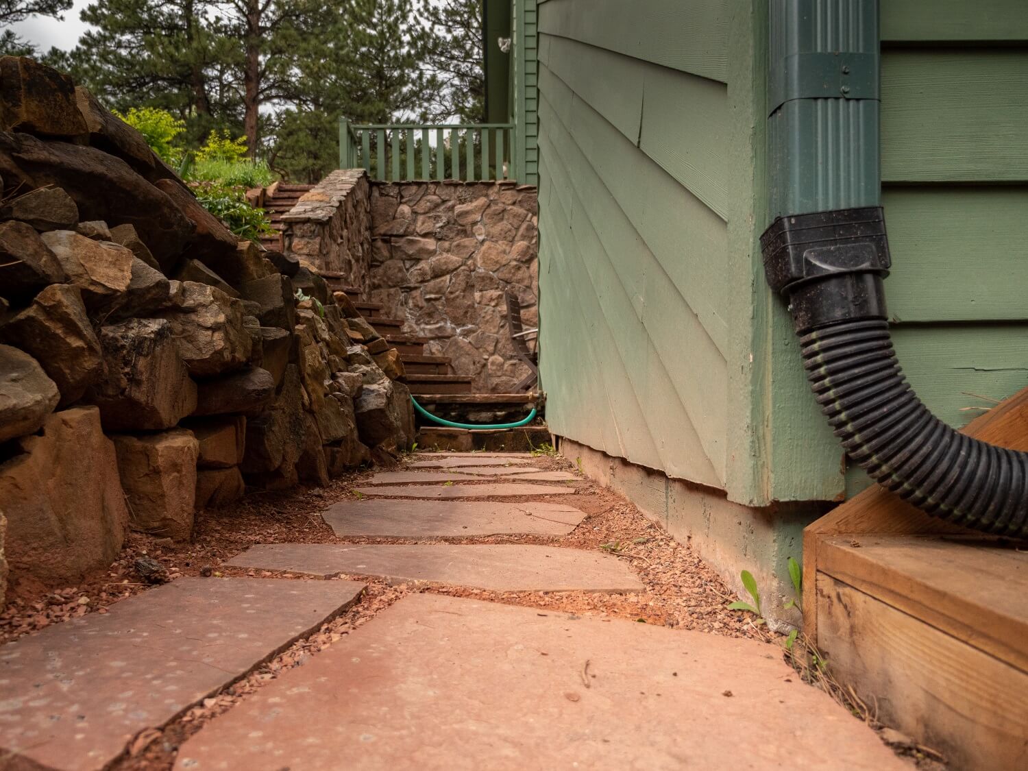 Wooden siding trimmed to expose concrete foundation