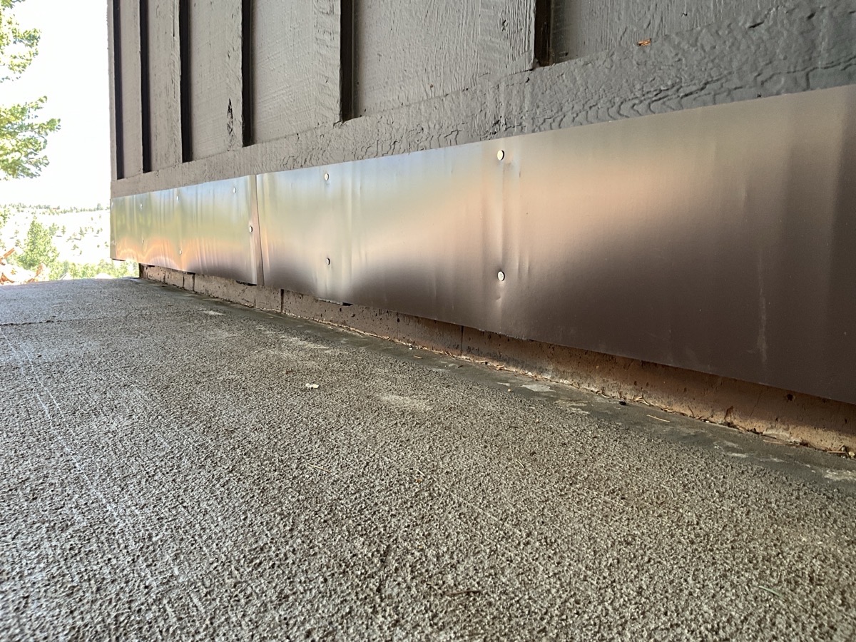 Overlay paintable metal flashing Metal flashing painted to match combustible home siding