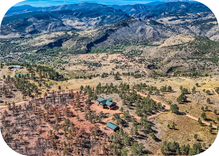 House on a hill overlooking mountain range