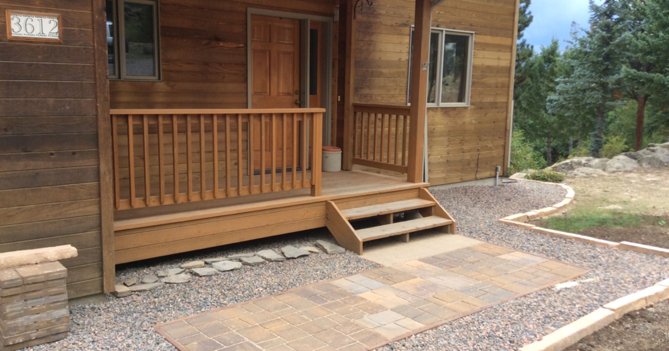 House with a non-combustible barrier around the base of the house, approximately 5 feet wide