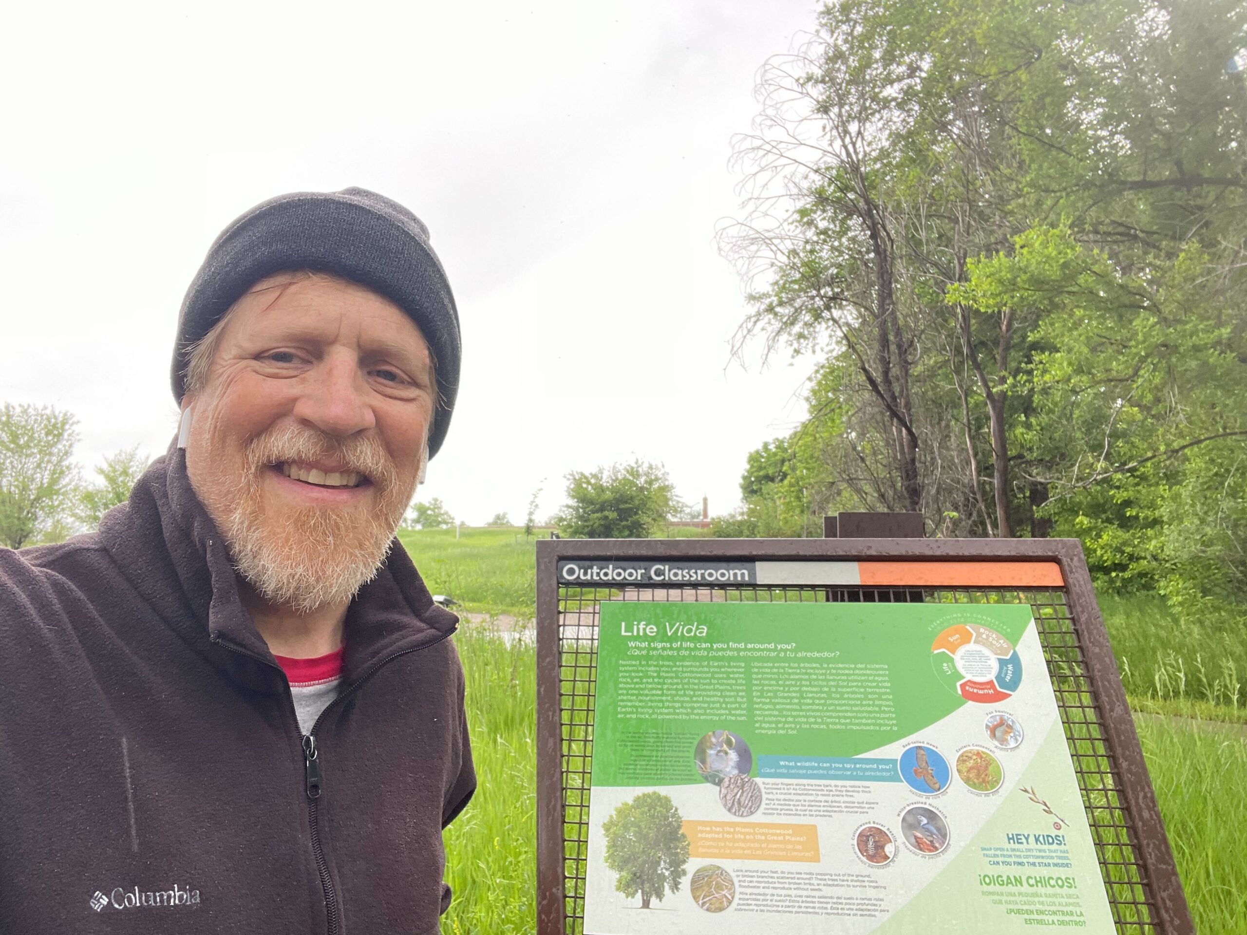 Andy McCullough standing in front of trail sign