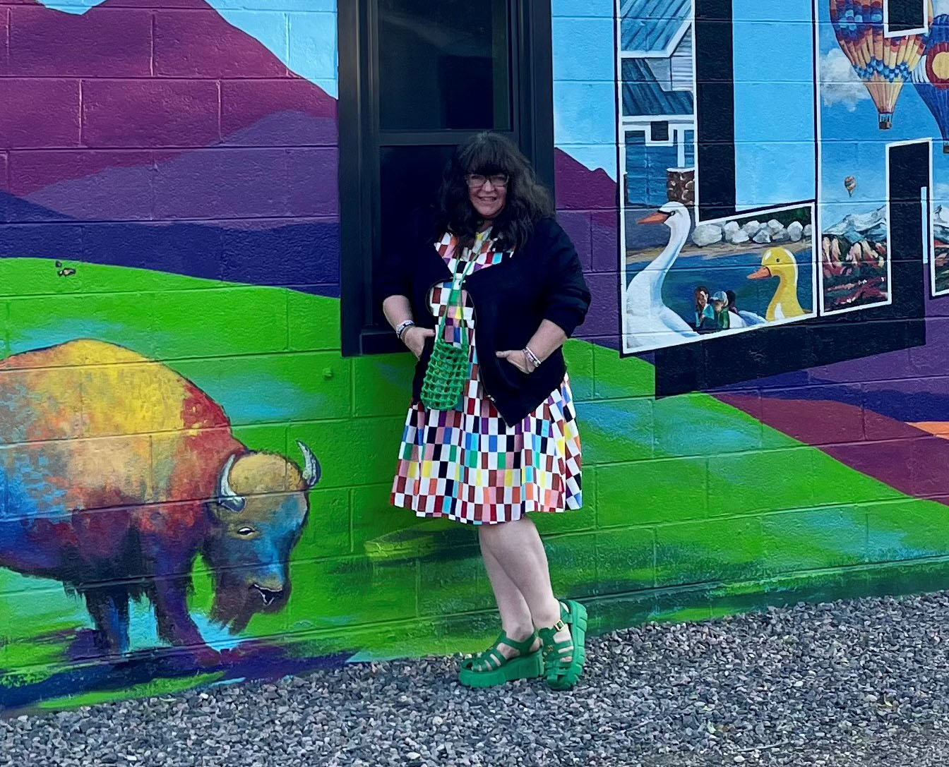 Julie Piller in front of Greetings from Lafayette mural