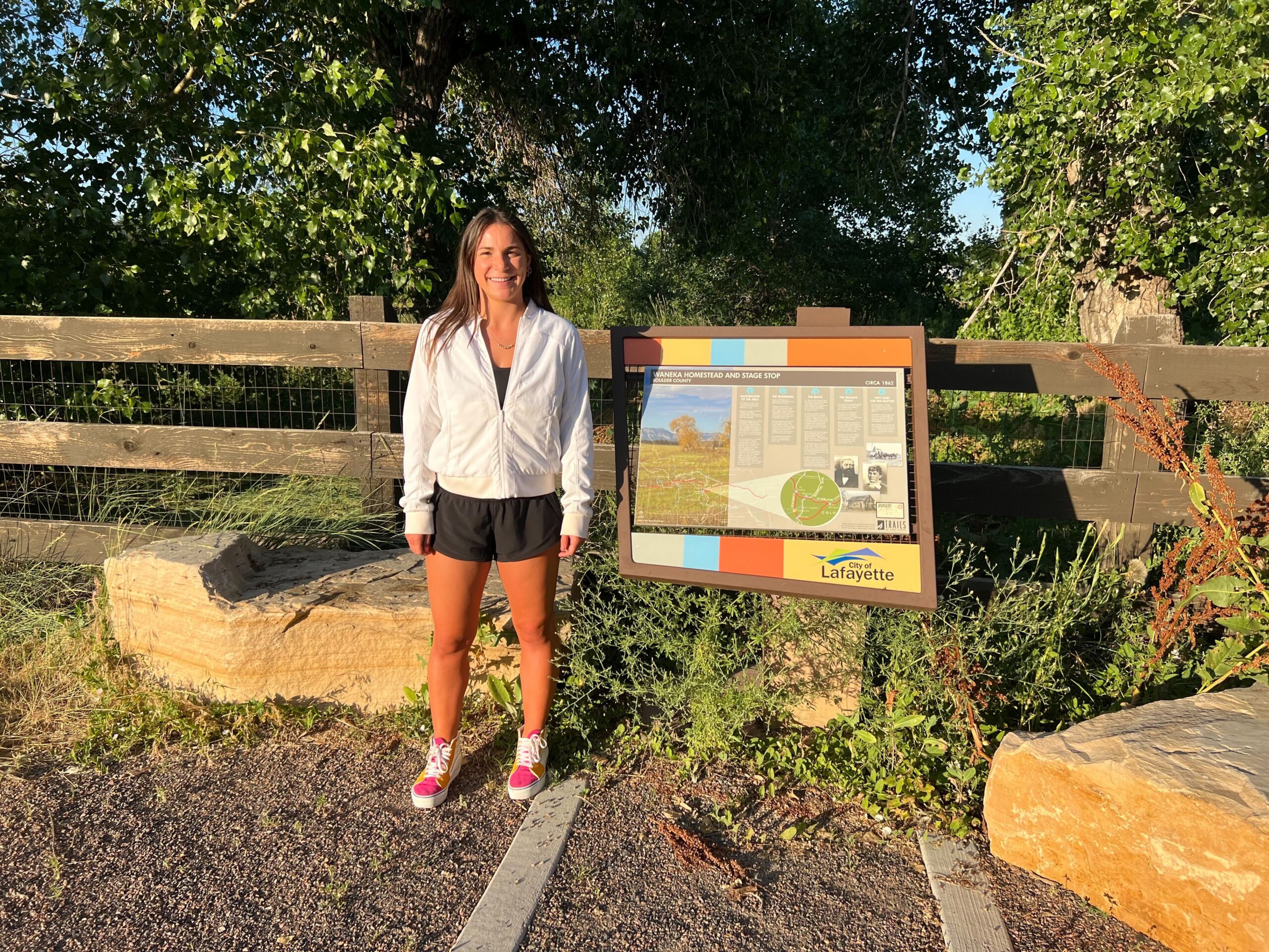 Lindsey Rosen standing in front of trail sign