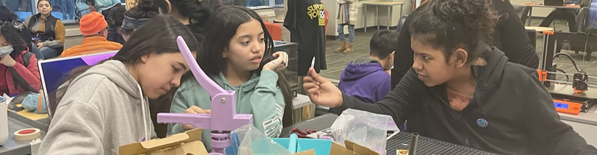 girls making crafts at table