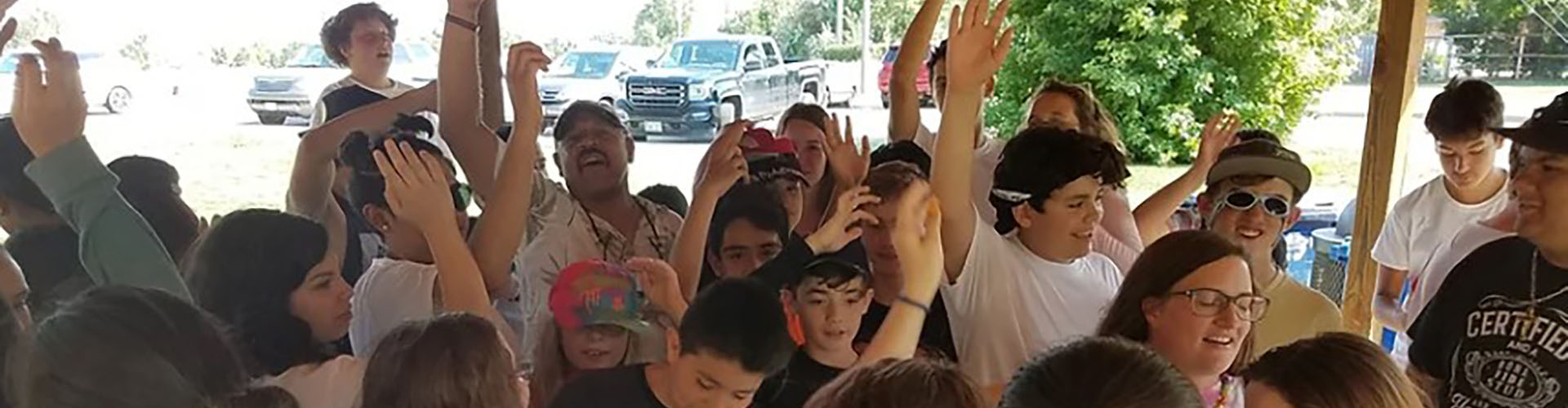 kids and adults cheering under a picnic shelter